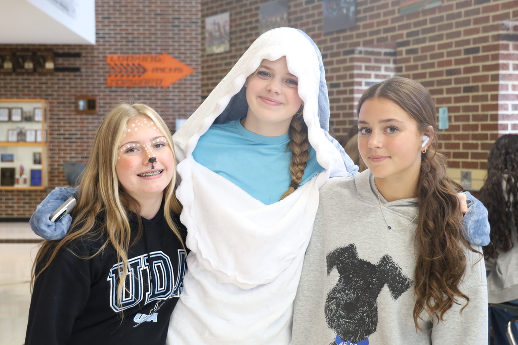 Three students one with face paint and another shark