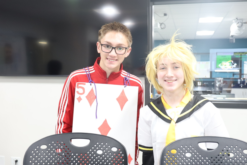 student as a  playing card 5 of diamonds. Another one dressed as a character
