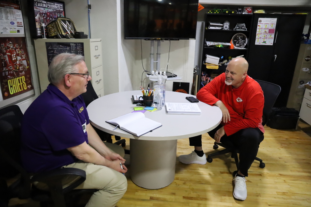 Marty Maciaszek and John Beerbower talking at a table together