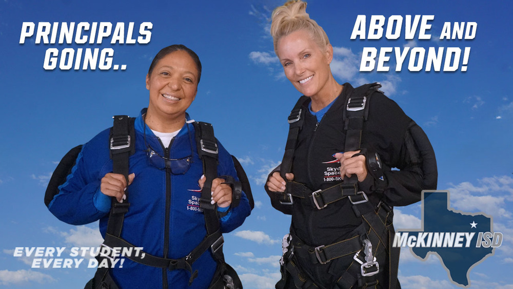 Holderman and Terrazas in front of Skydive facility sign smiling in a selfie