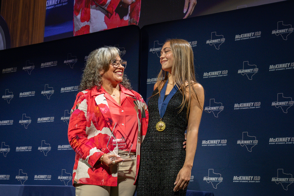 Raphaela Zentner and Lizbeth Testa smiling at each other onstage
