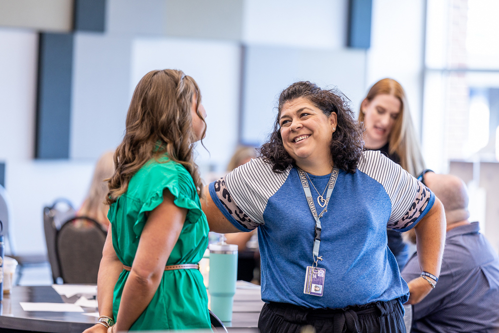 two female administrators talking and smiling