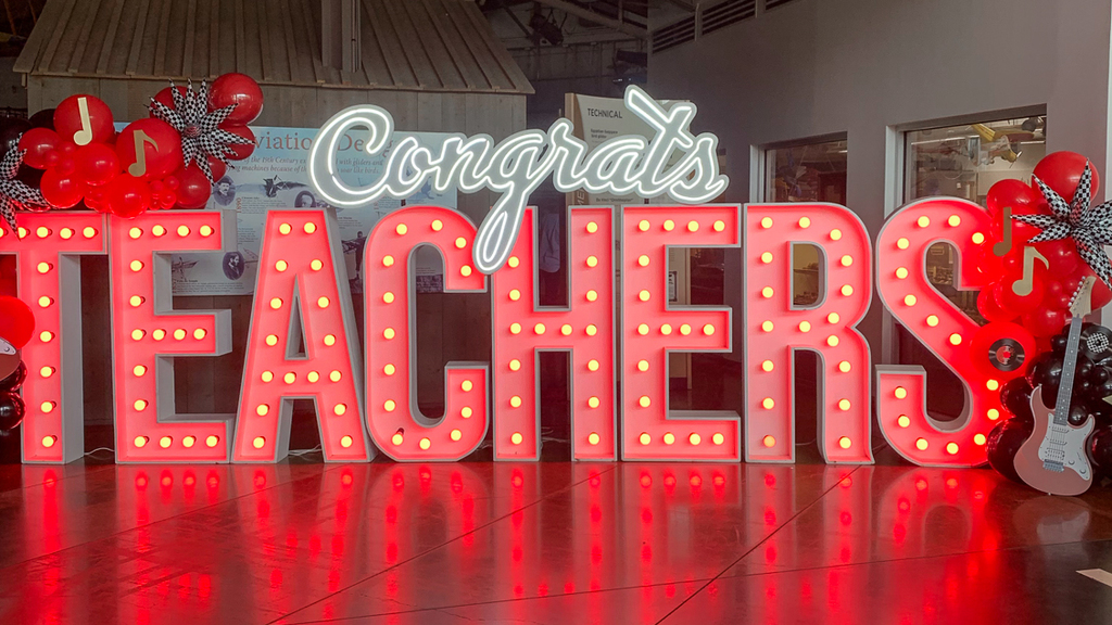 large letter lighted letter sign that reads Congrats Teachers