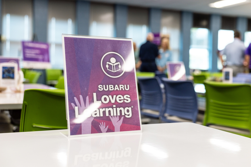 sign on table that reads Subaru Loves Learning
