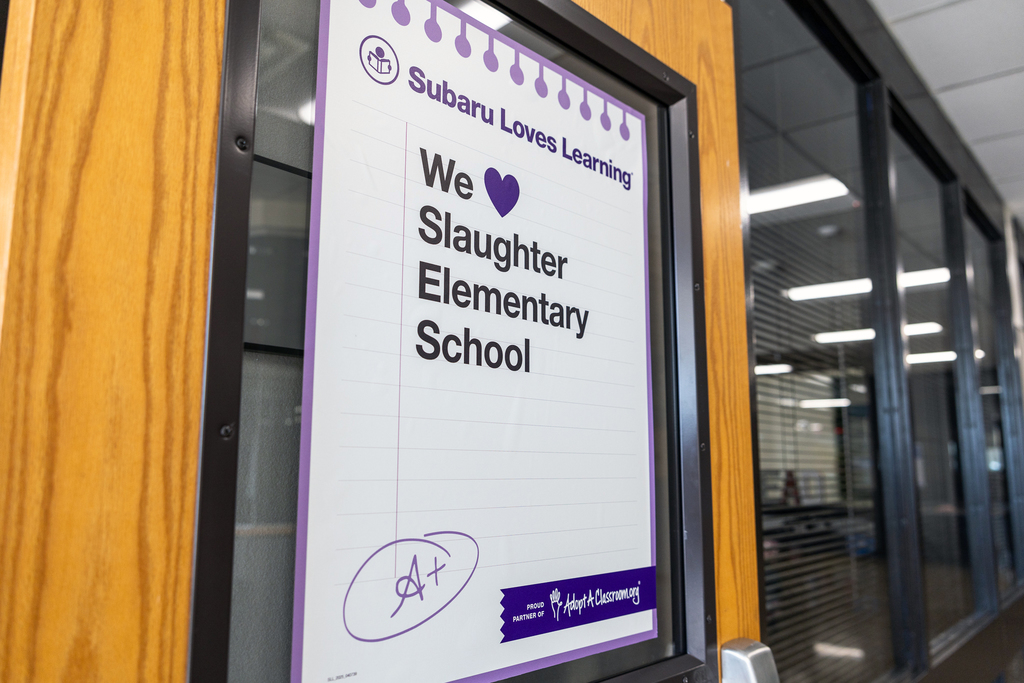 Sign on door that reads Subaru Loves Learning, We heart Slaughter Elementary School, A+