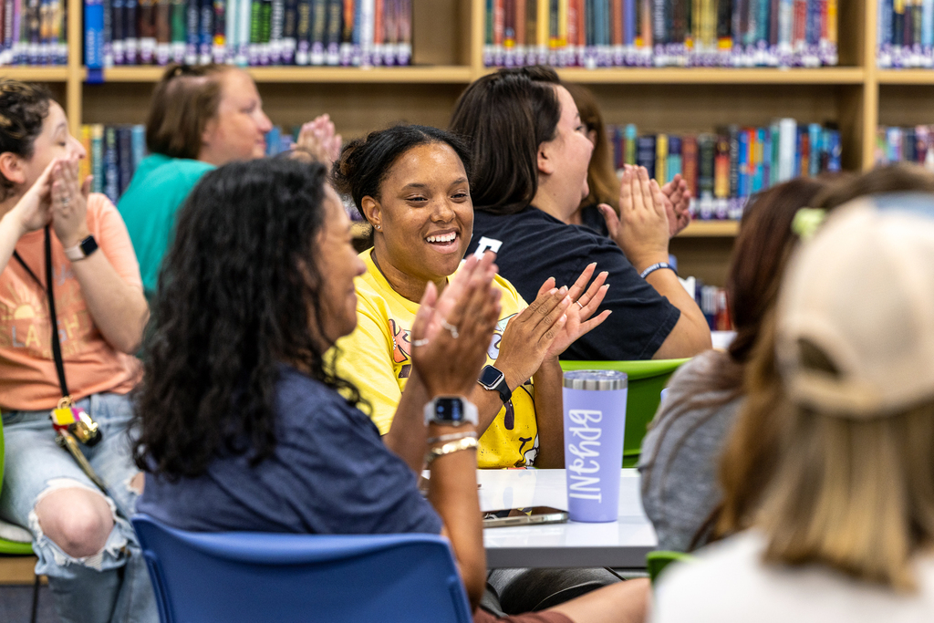 teachers clapping and smiling