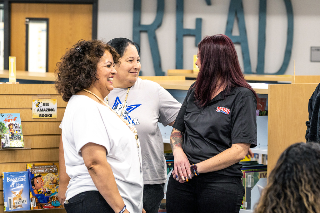 two female teachers laughing with Brandon Tome Subaru employee