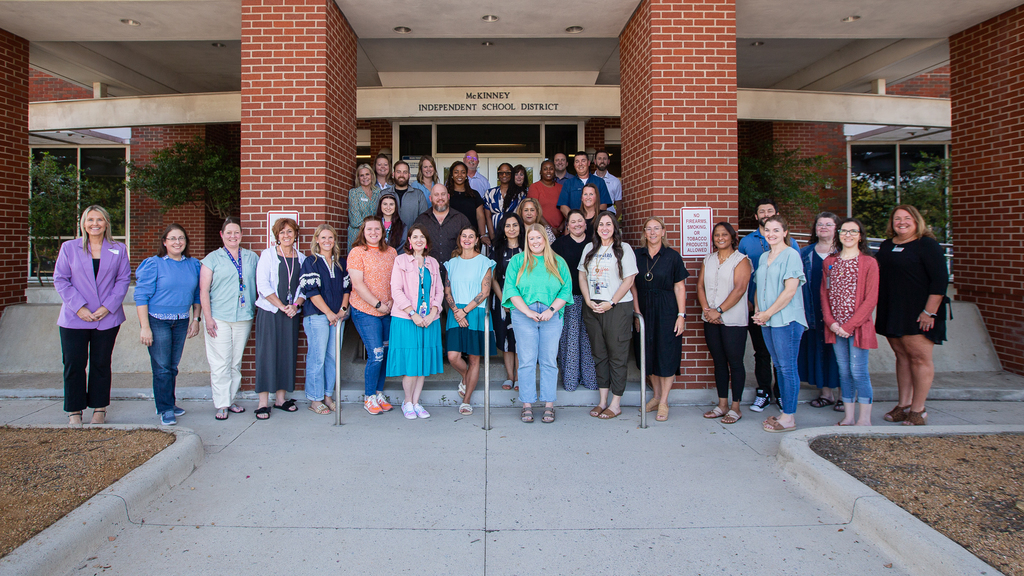 group photo of participants and leaders in front of the MISD administration building