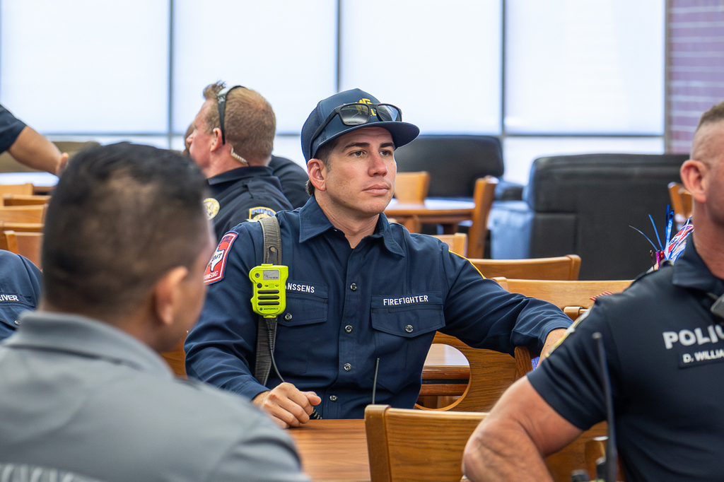 young male firefighter sitting in the library waiting for the parade time