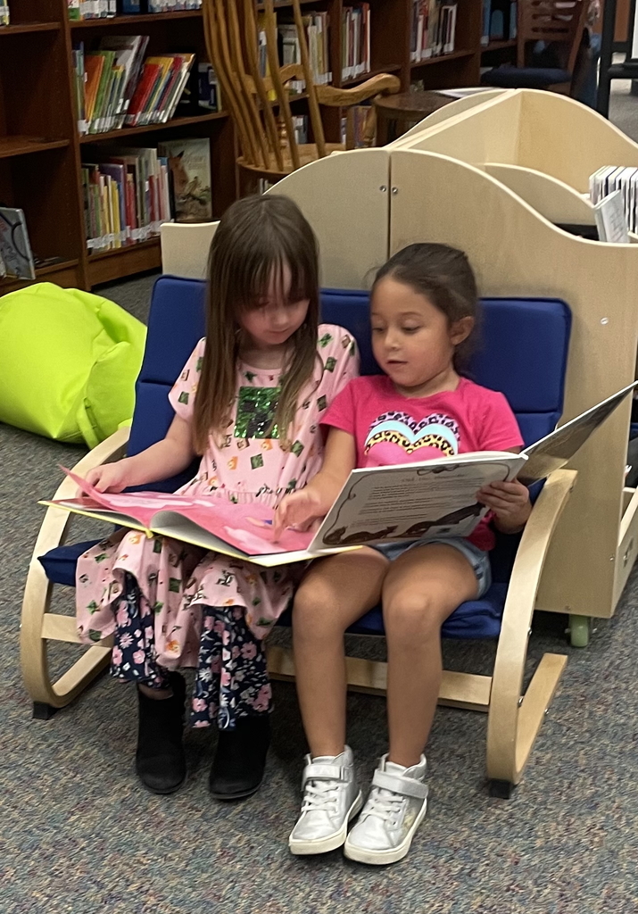 Kindergarten students read in their own special way.
