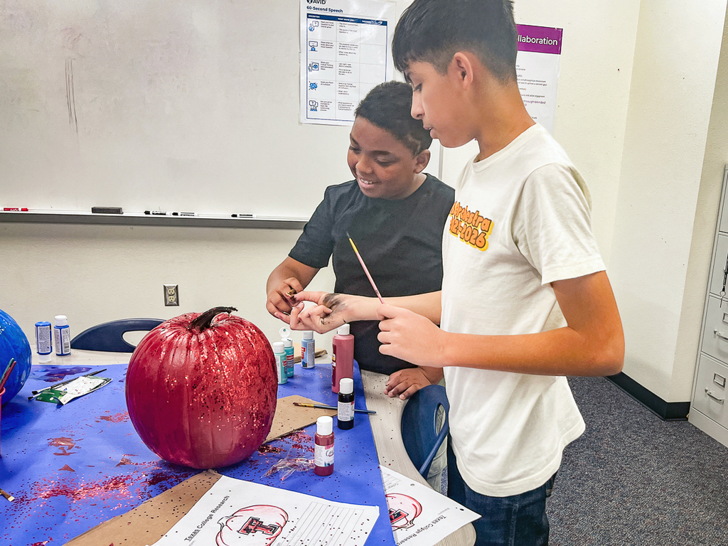 boys painting a pumpkin
