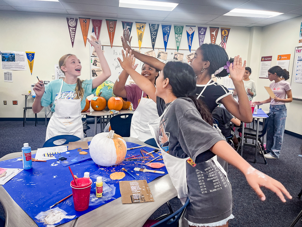 girls in a group high fiving one another
