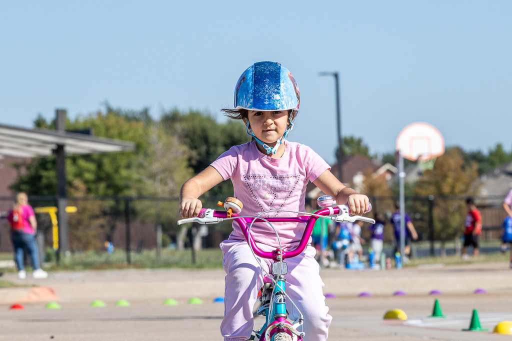 girl on bike riding directly toward camera