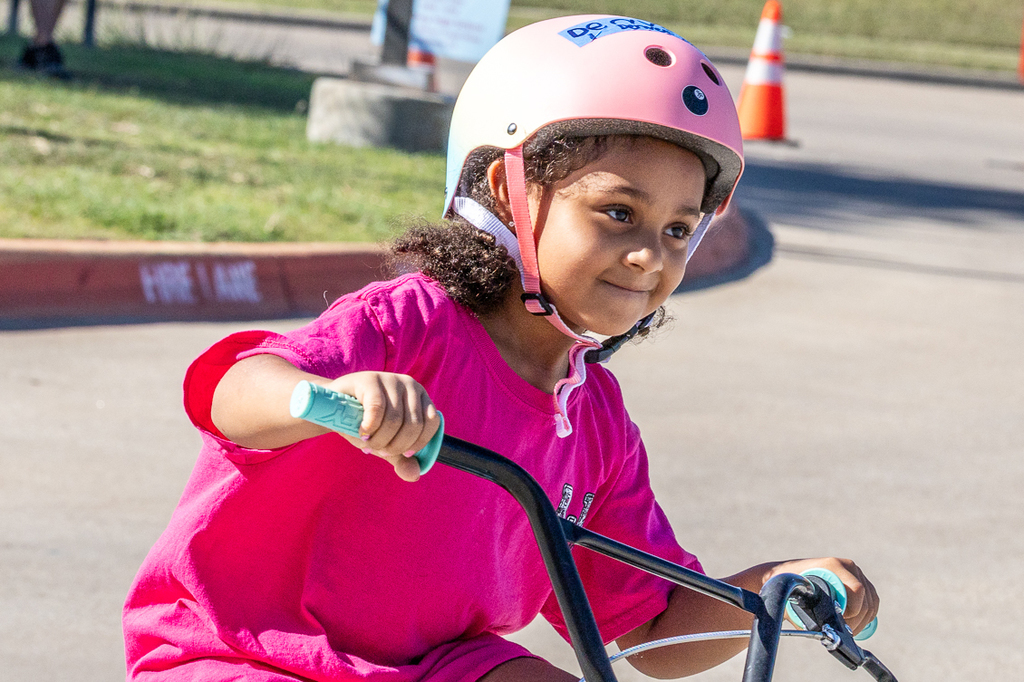girl on bike with smile on face