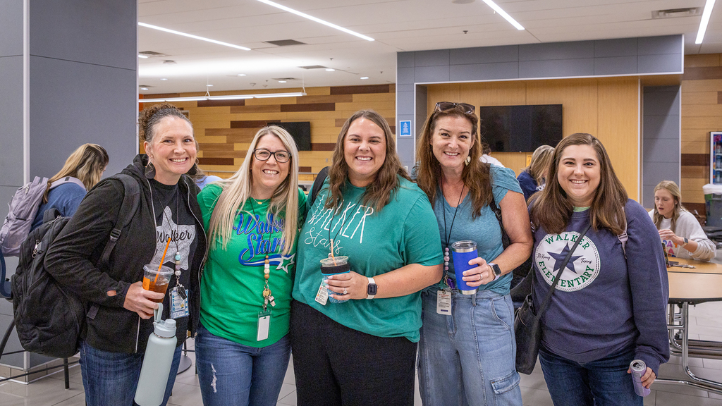 group of female teachers from Walker standing in a row and smiling