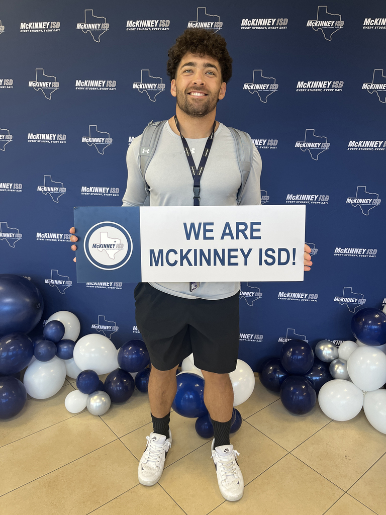 male coach holding up we are mckinney isd sign