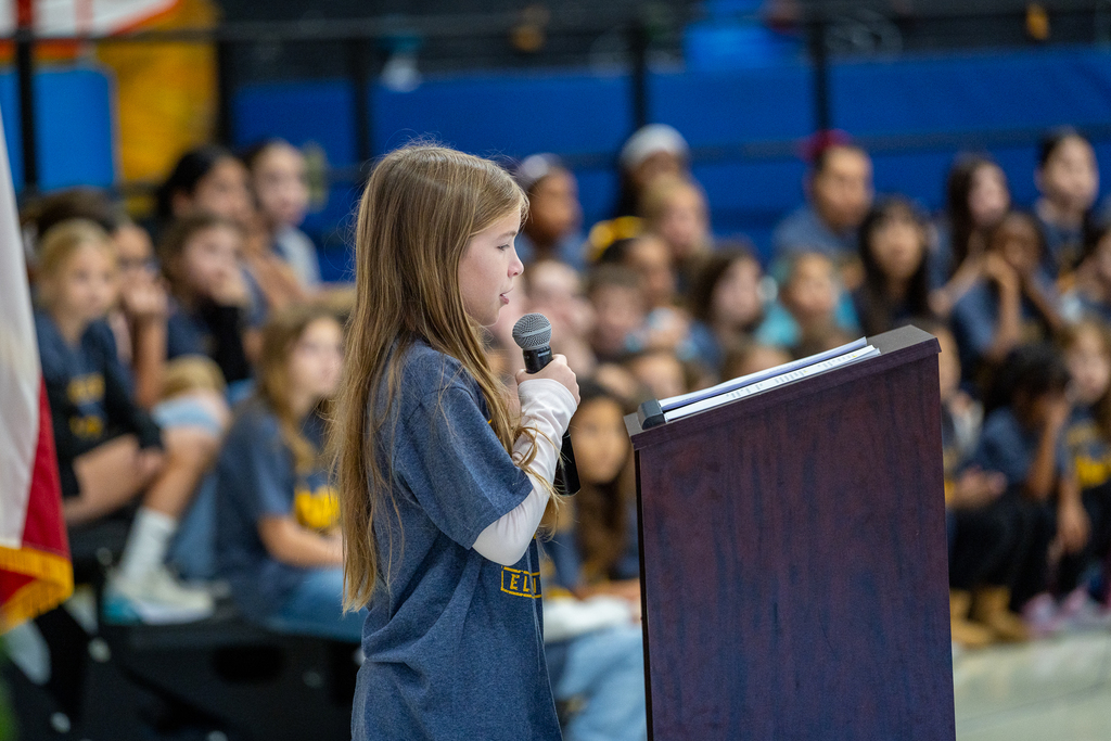 female student at the podium speaking
