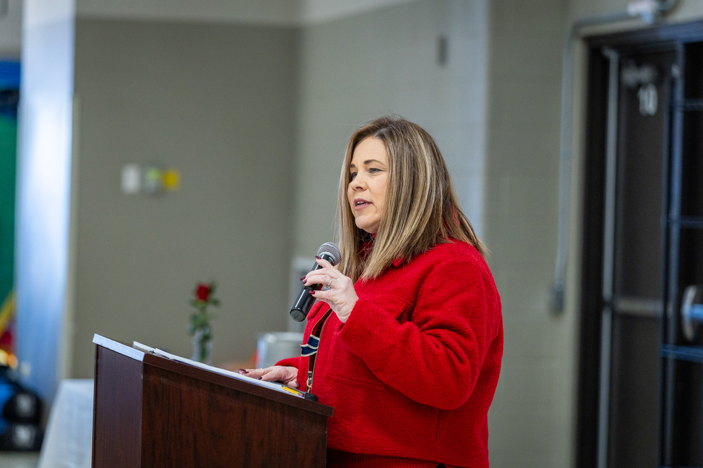 Principal Maria Hafner at the podium welcoming everyone