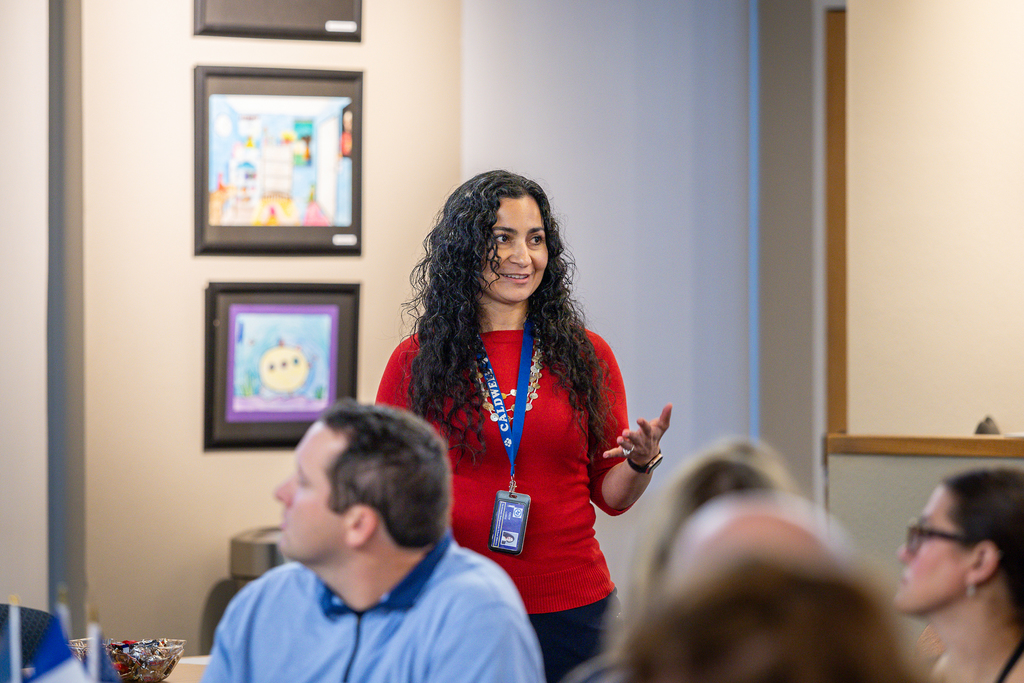 female particpant standing and talking to the group