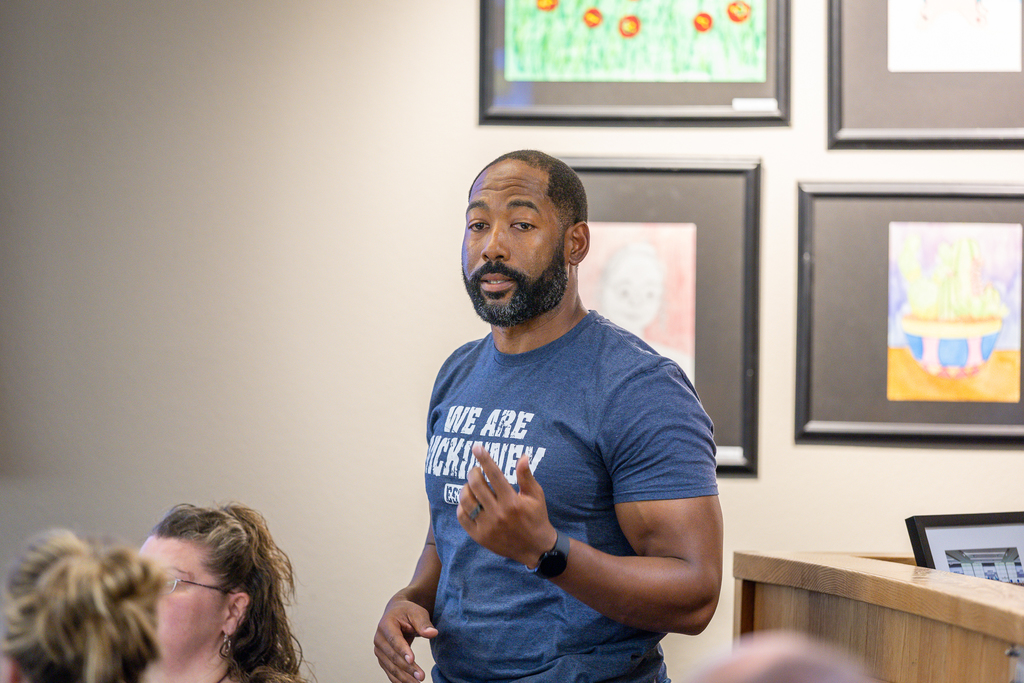 male participant standing and speaking 