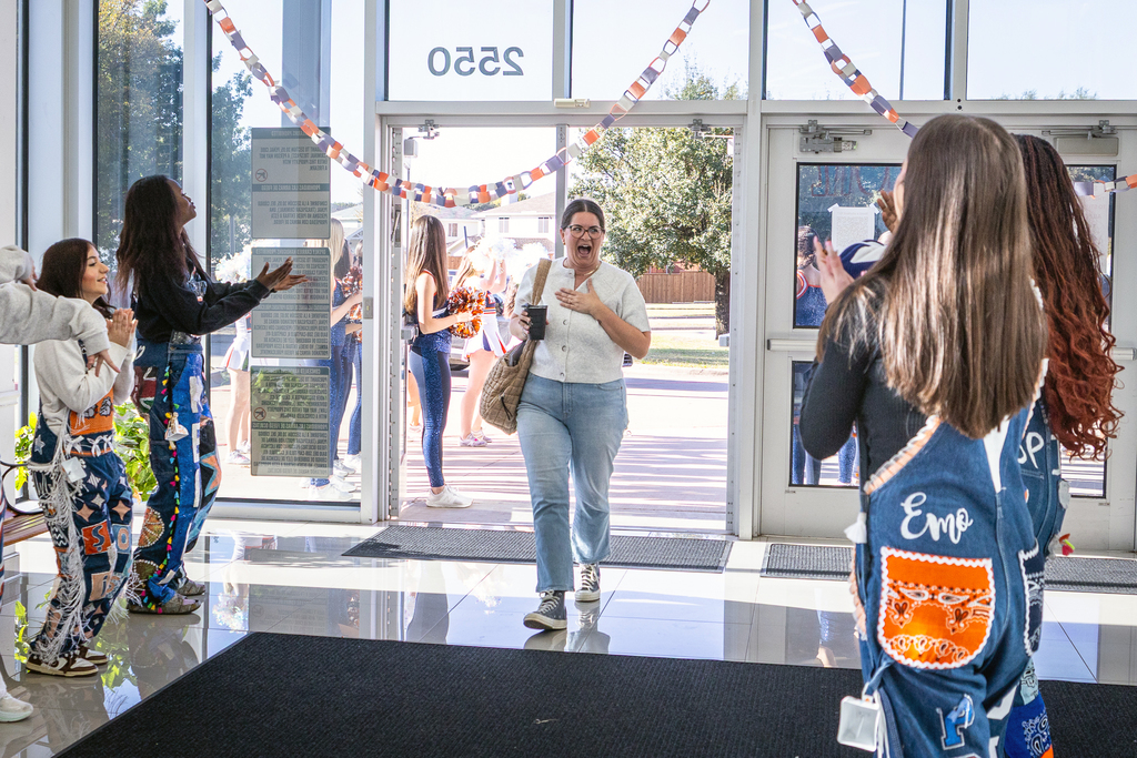 woman entering door and reacting excitedly to Guard Dawgs greeting her