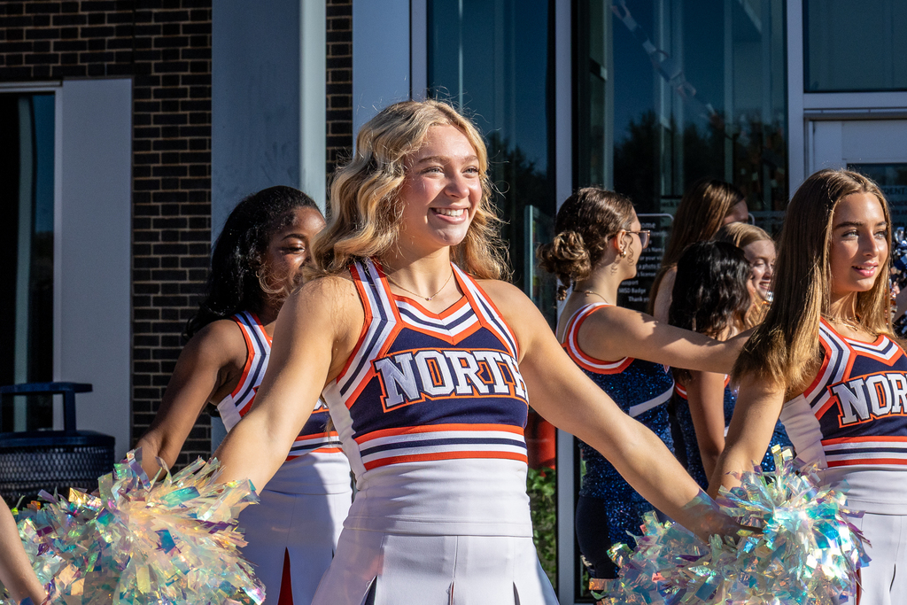 North cheerleader smiling with poms