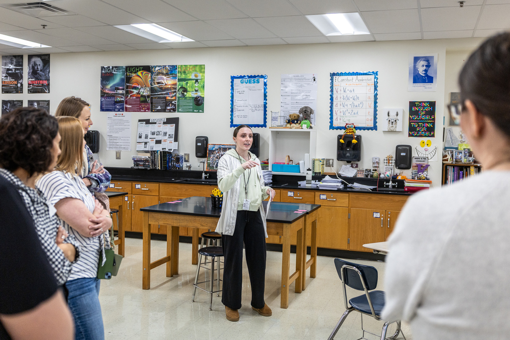 female student tour guide talking with tour group