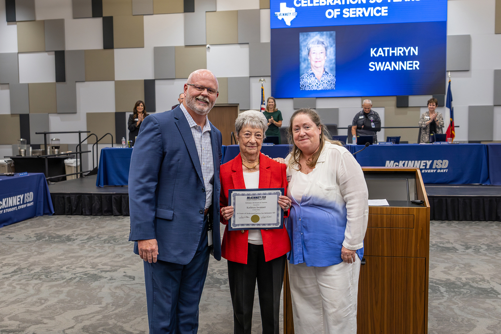 Kathryn Swanner with certificate at board meeting