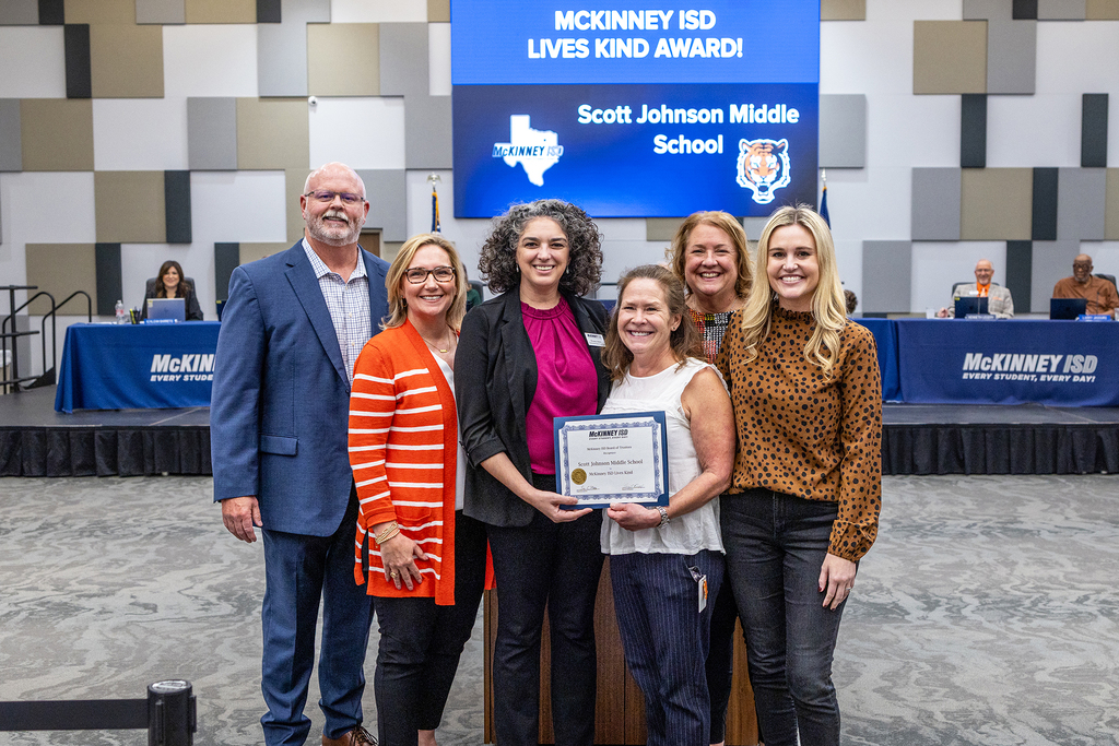 SJMS Principal and staff members with certificate at board meeting