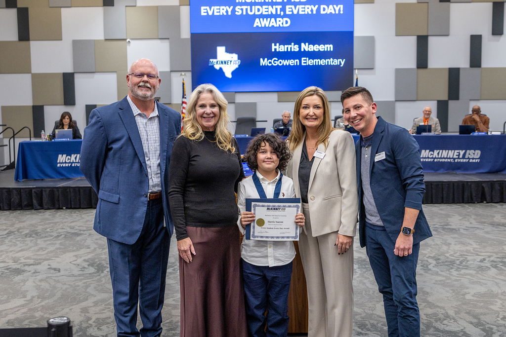 Harris Naeem with certificate at board meeting
