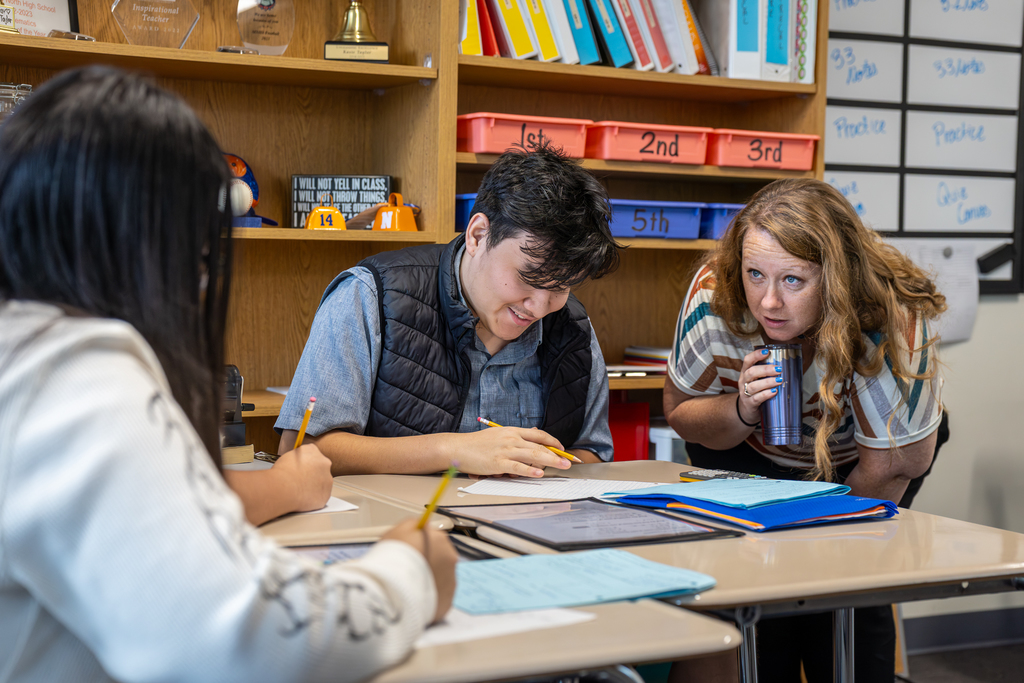 Kasie Taylor talking to students as they work on a project