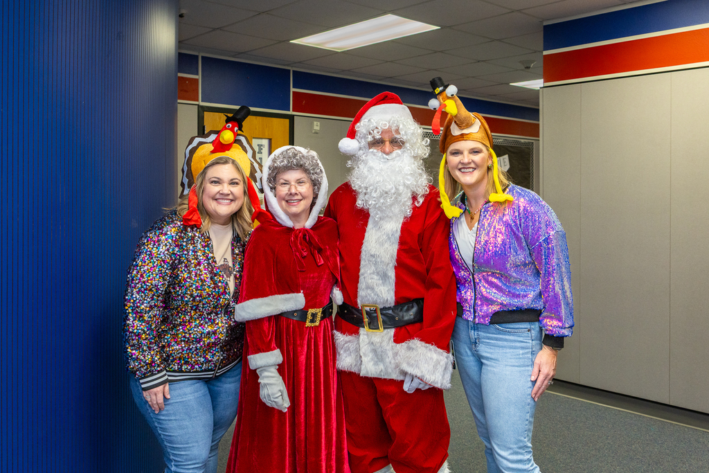 santa and mrs claus with principal Kassie Halpin and AP Anita Tillson