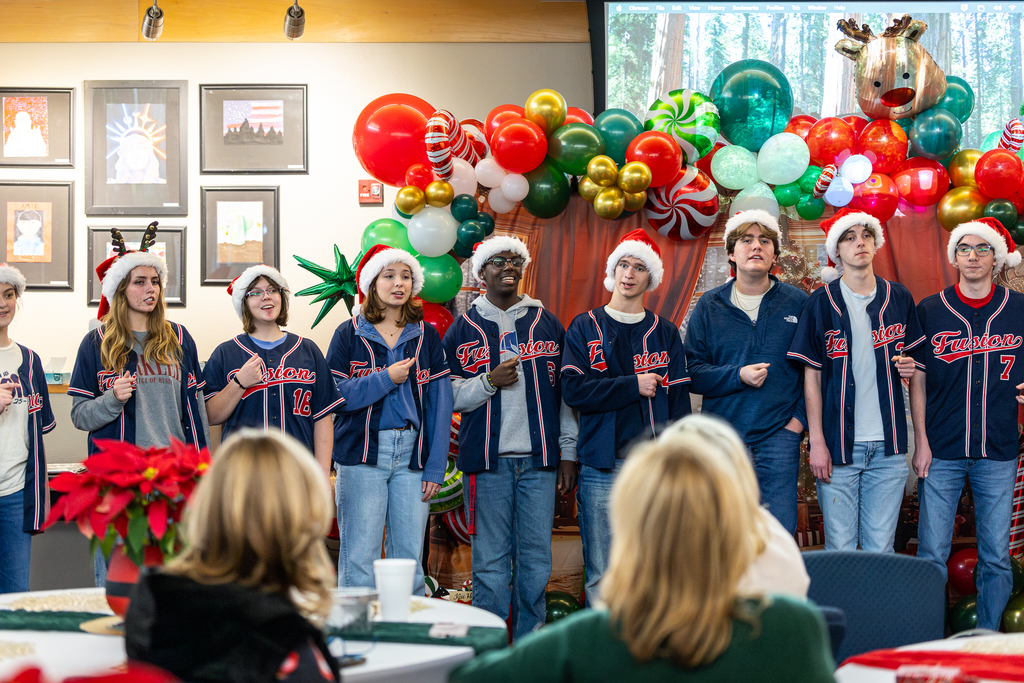 male and female singers in a single line snapping and singing