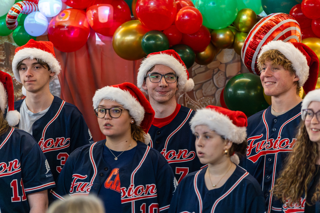 male singers trying not to laugh during performance