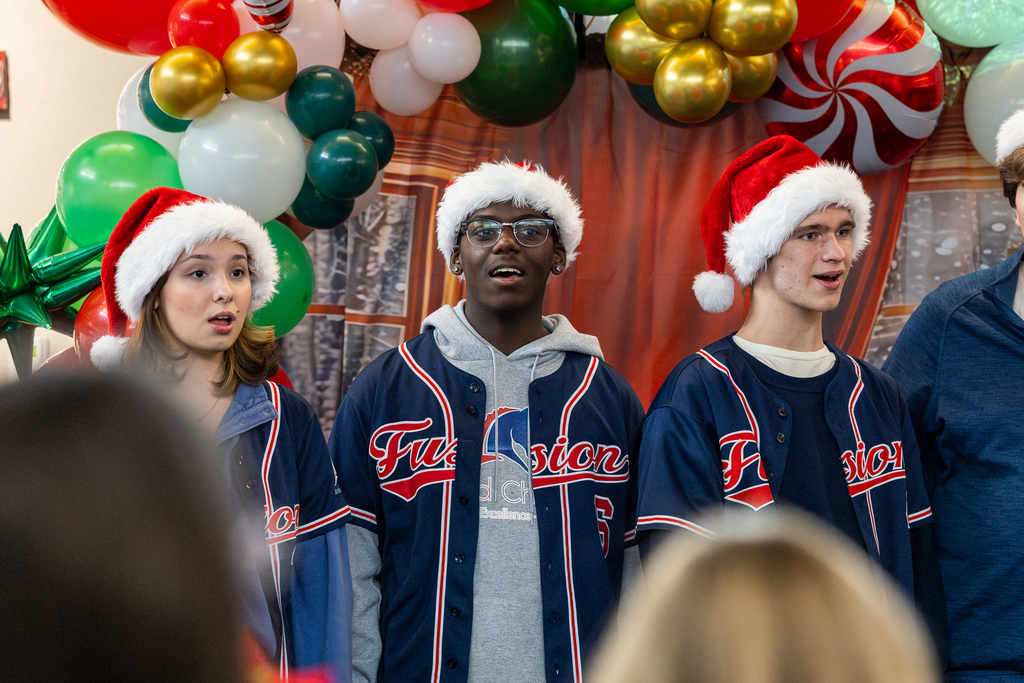 male and female singers in a line singing