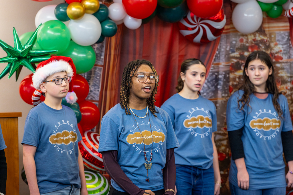 female choir member singing a solo as the rest look on