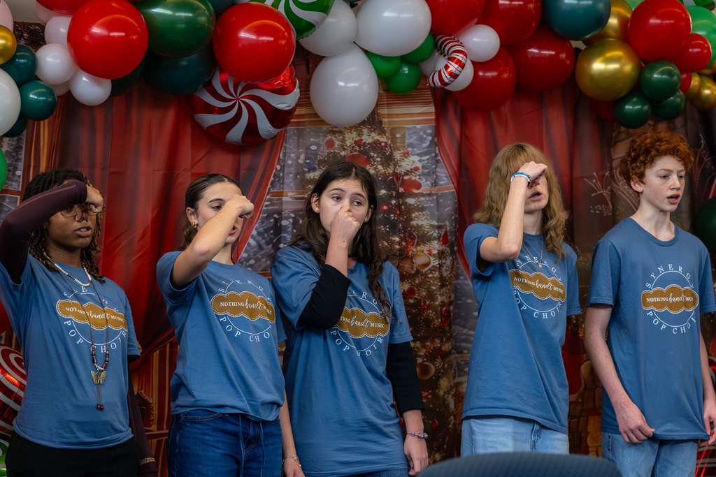 group holding their noses as they sing Grinch song