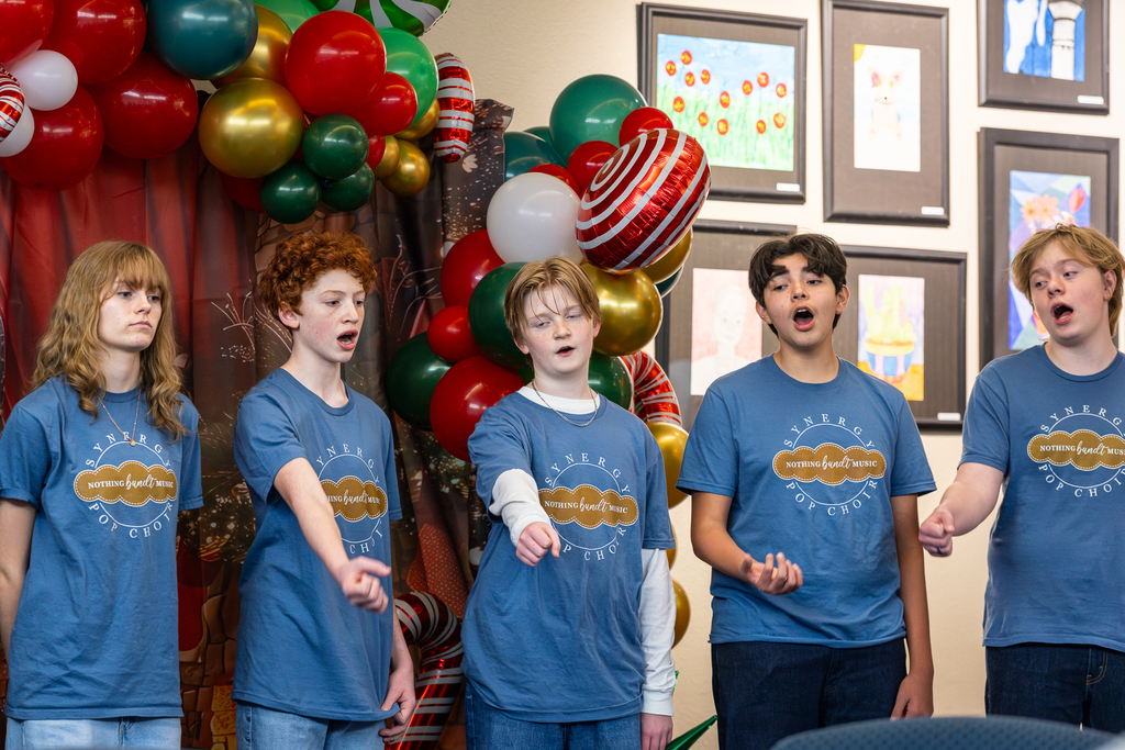 male choir members singing and gesturing with their fists extended