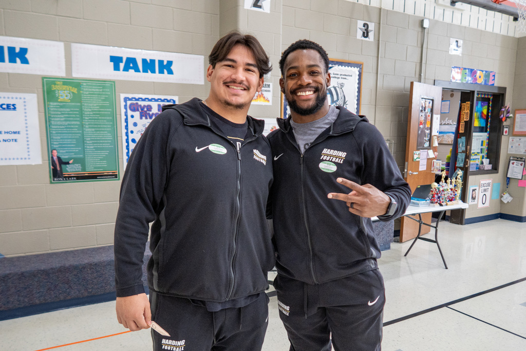 two Harding players smiling for the camera