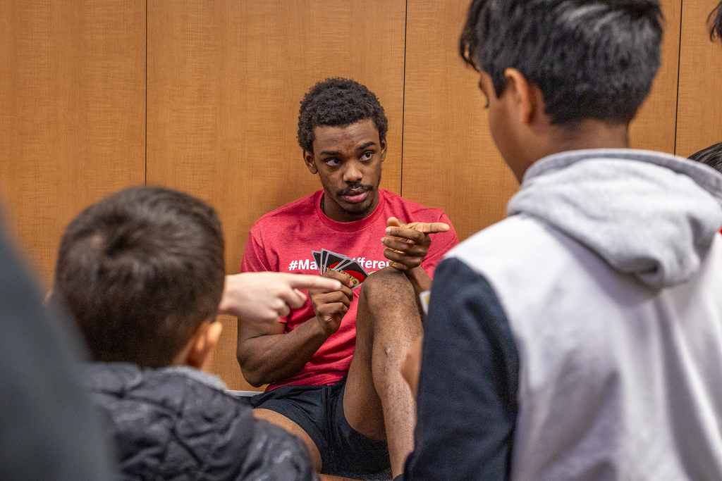 Ferris State player pointing at a student as they play a game