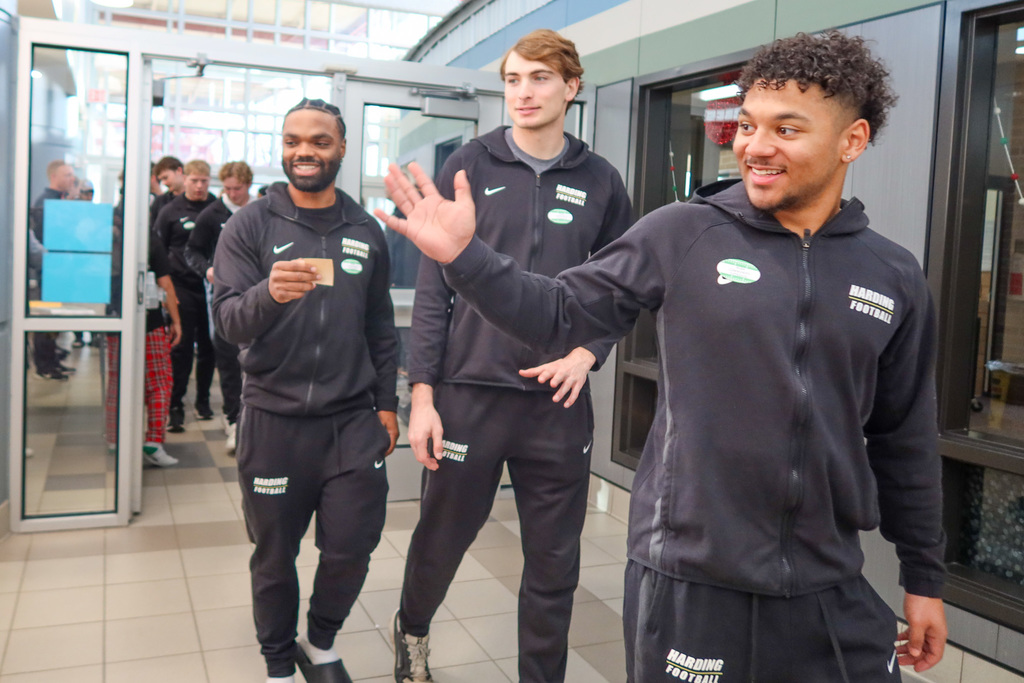 Harding players walking in and waving