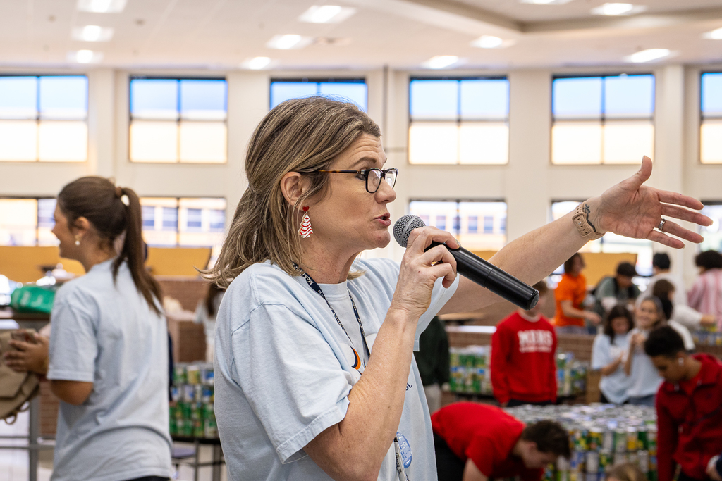 teacher with microphone giving instructions to group