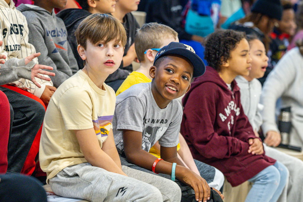 Male students look over at Larry Jagours in the gym at Slaughter
