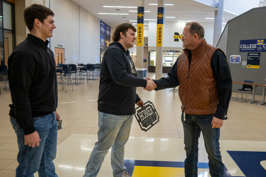 corey homer greets students at mckinney high school
