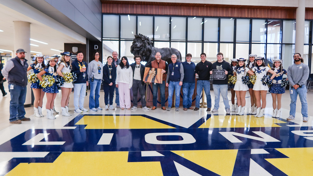 corey homer with the mhs marquettes mhs students and mhs administration