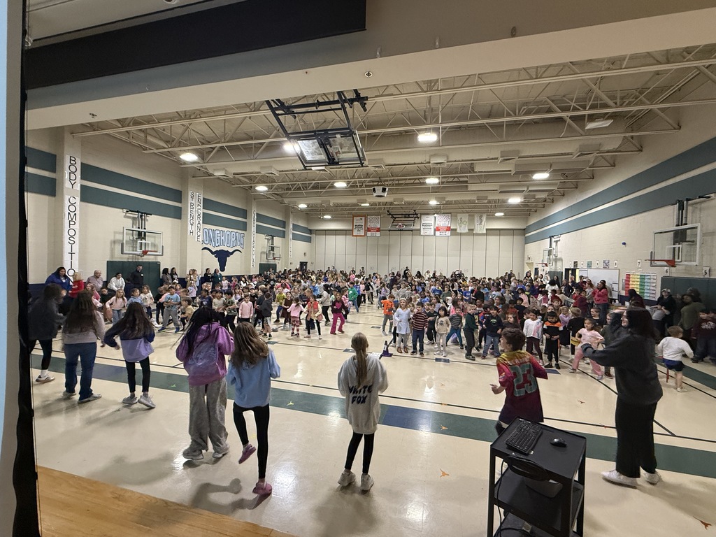 The student body dancing to the Cotton Eye Joe.