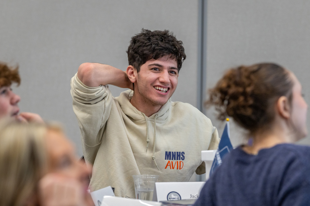 male student laughing as he reacts to the game the group is playing