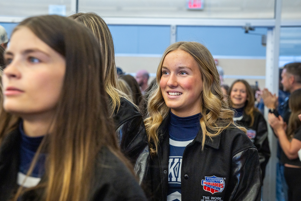 cheerleader smiling as group walks into the library