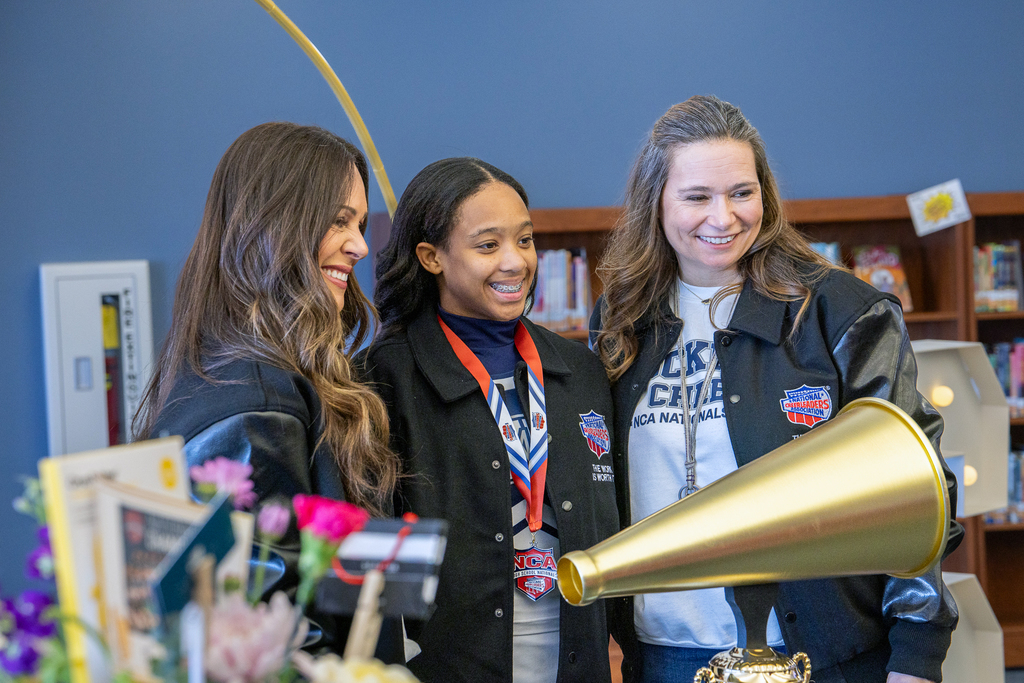 girl with coaches getting photo