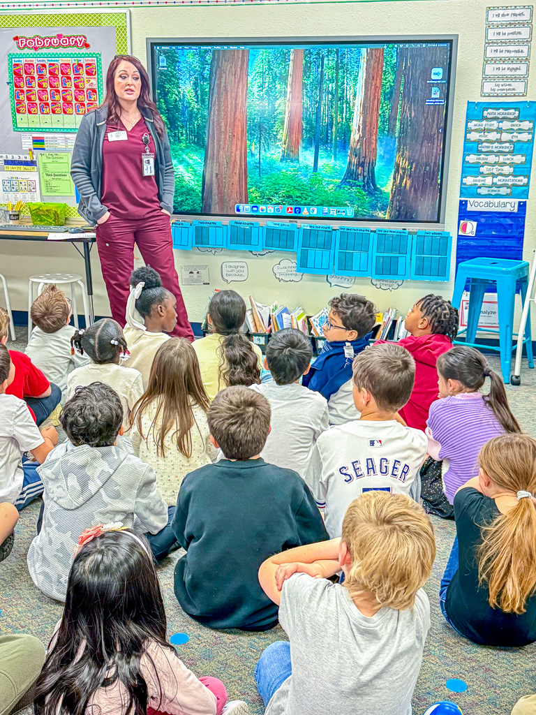 woman in nurse attire in front of class speaking